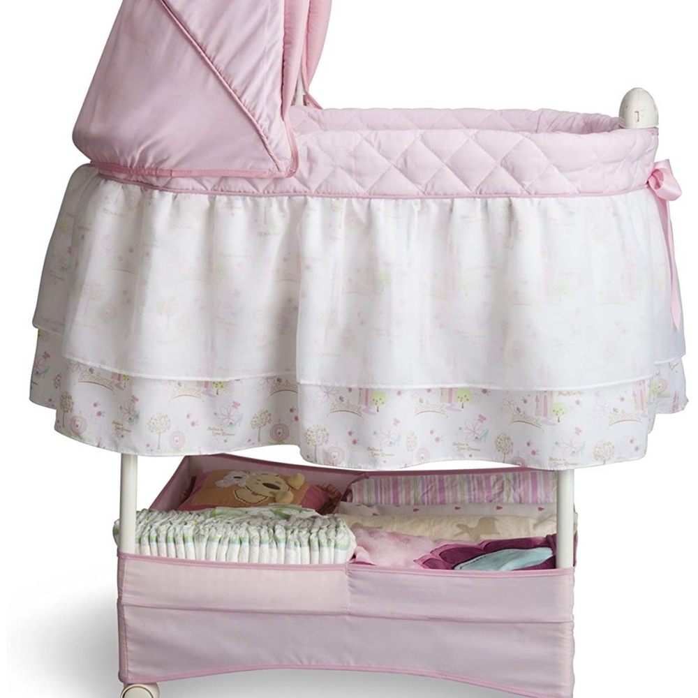 Pink and white bassinet with baby music included